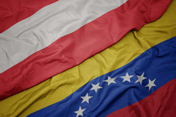 waving colorful flag of venezuela and national flag of austria.