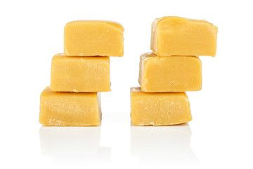 Group of six whole sweet golden caramel candy isolated on white background