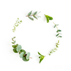 Round wreath frame made of mix of herbs, green branches, leaves mint, eucalyptus, thyme and plants collection on white background. Set of medicinal herbs. Flat lay. Top view.