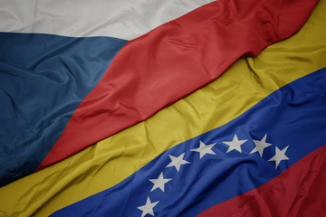 waving colorful flag of venezuela and national flag of czech republic.