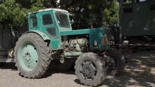 An old tractor is used for repair work.