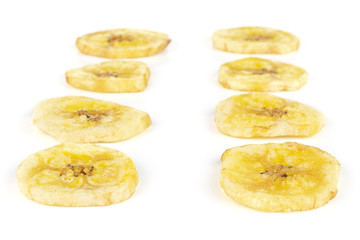 Group of eight slices of sweet yellow dry banana isolated on white background