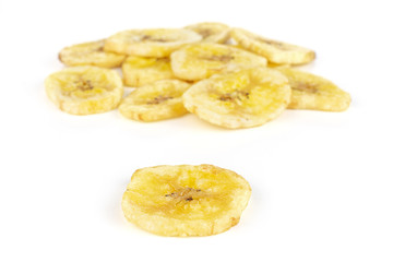 Lot of slices of sweet yellow dry banana isolated on white background
