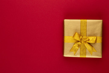 Christmas, holiday present box on red background.