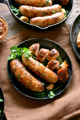 Roasted sausages in frying pan