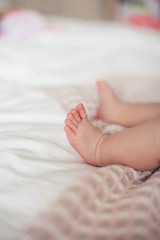 Closeup of a little girl's leg. Baby. Children bedroom. Cozy.