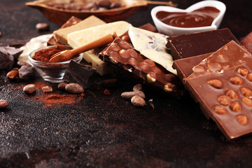 Melting chocolate, melted chocolate and chocolate swirl with stack and chips on table