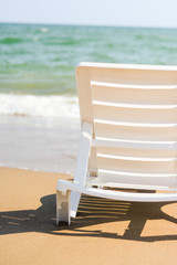 Naklejka premium Sunbed on the beach close-up on a background of the sea