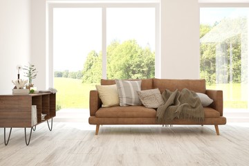 Stylish room in white color with sofa and summer landscape in window. Scandinavian interior design. 3D illustration