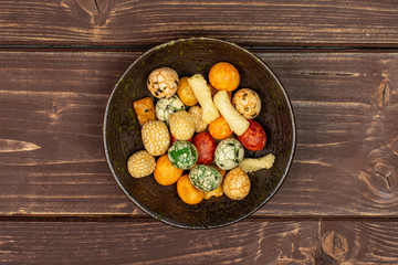 Lot of whole rice japan assortment in dark ceramic bowl flatlay on brown wood