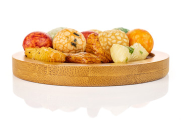 Lot of whole rice japan assortment on round bamboo coaster isolated on white background