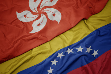 waving colorful flag of venezuela and national flag of hong kong.