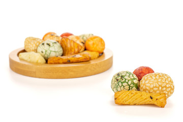 Lot of whole rice japan assortment on round bamboo coaster isolated on white background