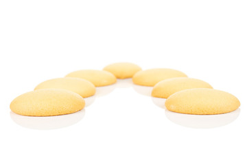 Group of seven whole sweet golden sponge biscuit isolated on white background