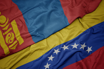 waving colorful flag of venezuela and national flag of mongolia.
