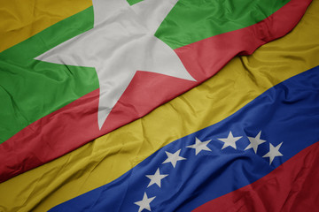 waving colorful flag of venezuela and national flag of myanmar.
