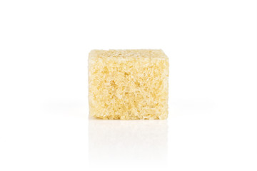 One whole sweet brown sugar cube isolated on white background