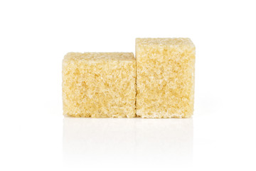 Group of two whole sweet brown sugar cube isolated on white background