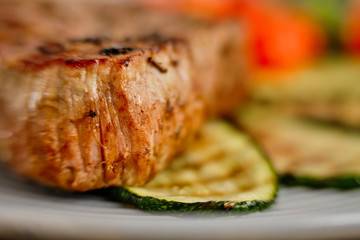 Closeup view of grilled beef steak. Macro shoot with soft focus.