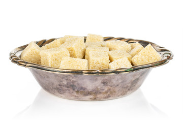 Lot of whole sweet brown sugar cube in metal bowl isolated on white background