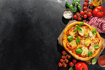 Homemade pizza with mozzarella on dark background