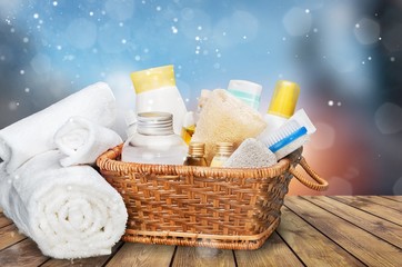 Bath towel and basket with accessories for spa on blur background