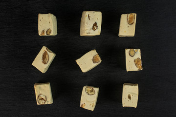 Group of nine whole sweet white nougat flatlay on grey stone