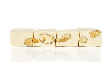 Group of four whole sweet white nougat in row isolated on white background