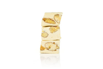 Group of three whole sweet white nougat in column isolated on white background