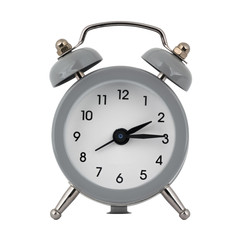 A gray clock with an alarm clock on a white background with arrows showing the time two hours fifteen minutes or fourteen hours fifteen minutes