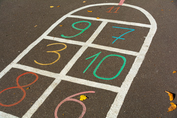 Hopscotch. Cells for game hopscotch drawn with multi-colored chalk on the pavement.