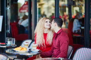 Beautiful romantic couple in Parisian outdoor cafe