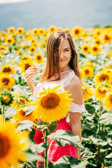 Outdoor portrait of beautiful young woman with sunflowers, health and lifestyle