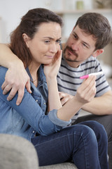 Fototapeta na wymiar sad woman shows negative pregnancy test