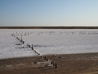 Abandoned remains of wooden structures on a salt lake