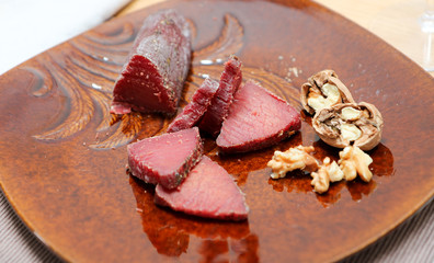 Air cured beef served with nuts and red wine