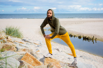 Man exercise and stretching by the sea
