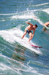 surfer iding the waves at pacific beach