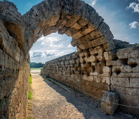 The stone archway leading to the historic stadium of the Ancient Olympia, archaeological site in Peloponnese, Greece