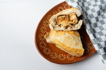 Mexican mole tamal sandwich also called "guajolota"