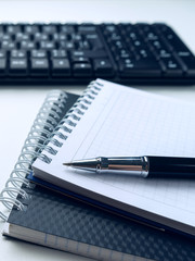 Office desk table with computer keyboard and supplies. On white background. Copy space. Mock up.
