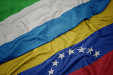 Fototapeta premium waving colorful flag of venezuela and national flag of sierra leone.