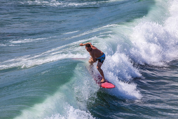 surfer iding the waves at pacific beach