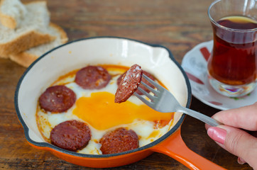 Turkish breakfast with fried egg,  sucuk and Turkish tea