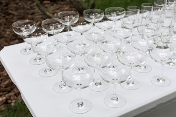 Many empty clean glasses for guests at the buffet festive wedding table