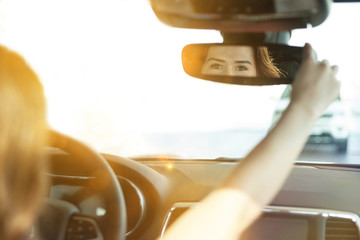 young woman driving car on the road