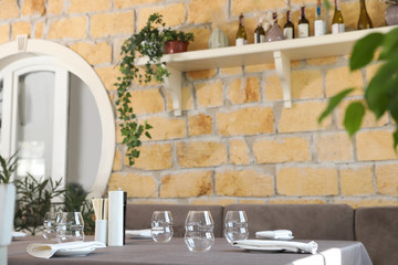 Table with plates and empty glasses in cafe