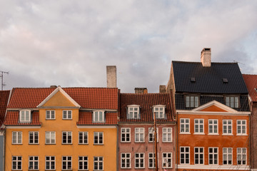 Partial view of the colorful facades of the typical houses in front of the Nyhavn canal in Copenhagen.