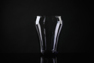 Elegant empty colorful glass on black background