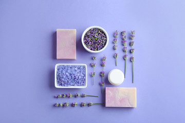 Flat lay composition with hand made soap bars and lavender flowers on violet background